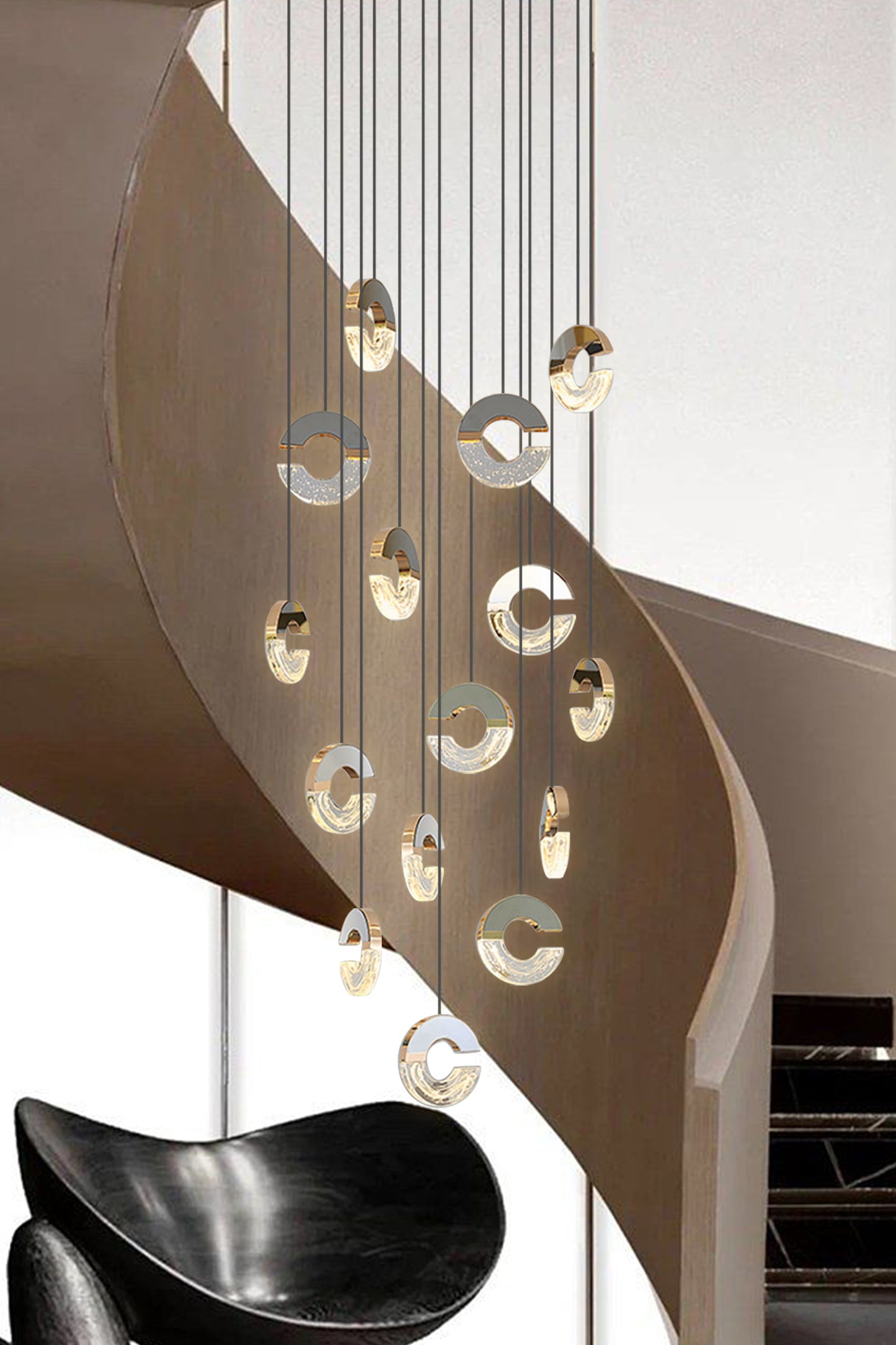 A luxurious pendant light hangs gracefully above the modern staircase, its shimmering light creating an enchanting ambiance.