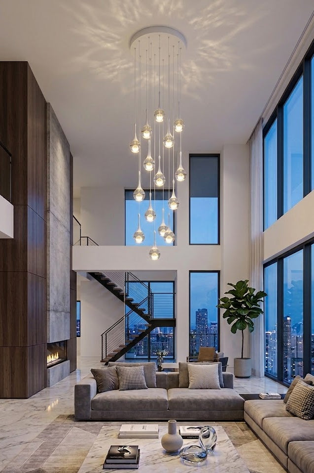 Modern living room with high ceilings, large windows, and a chandelier.
