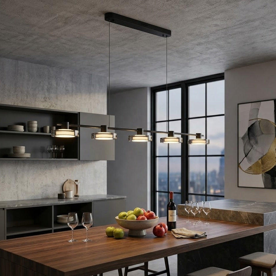 Modern kitchen with a dining table, wine bottles, and fruit.